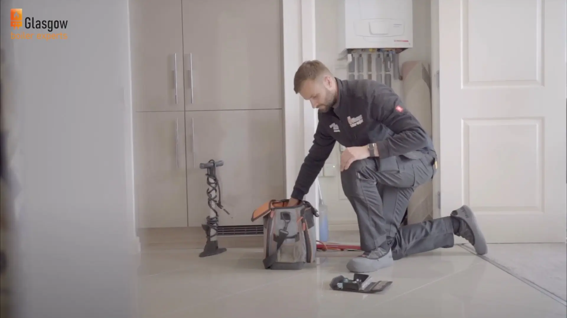 Boiler engineer servicing boiler in Glasgow home
